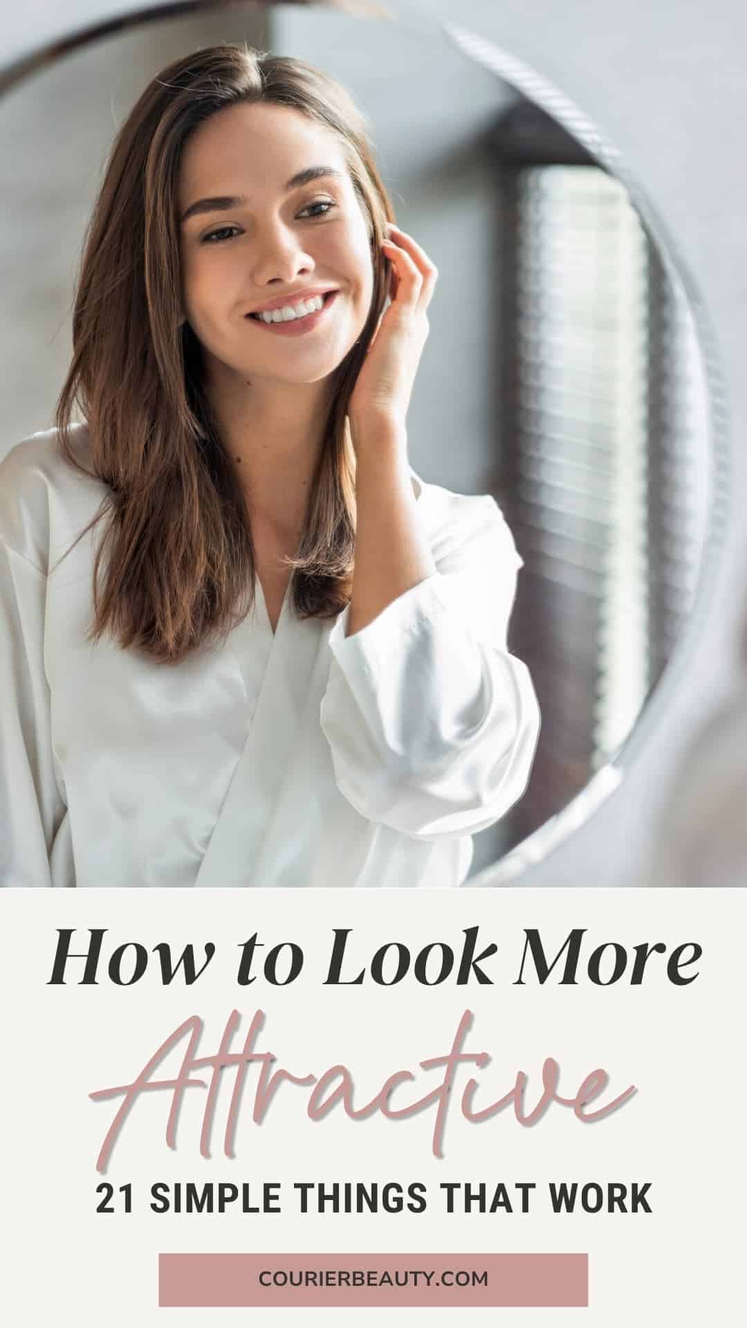 A woman in a white robe smiles at her reflection in the mirror while touching her hair.