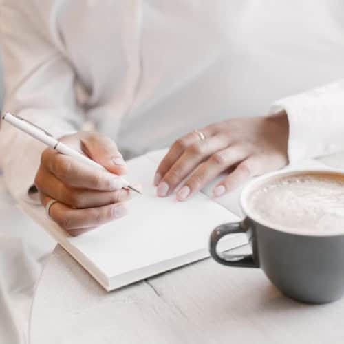 Woman writing in journal.