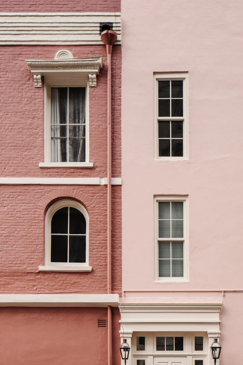 Two side by side pink and dusty rose buildings.